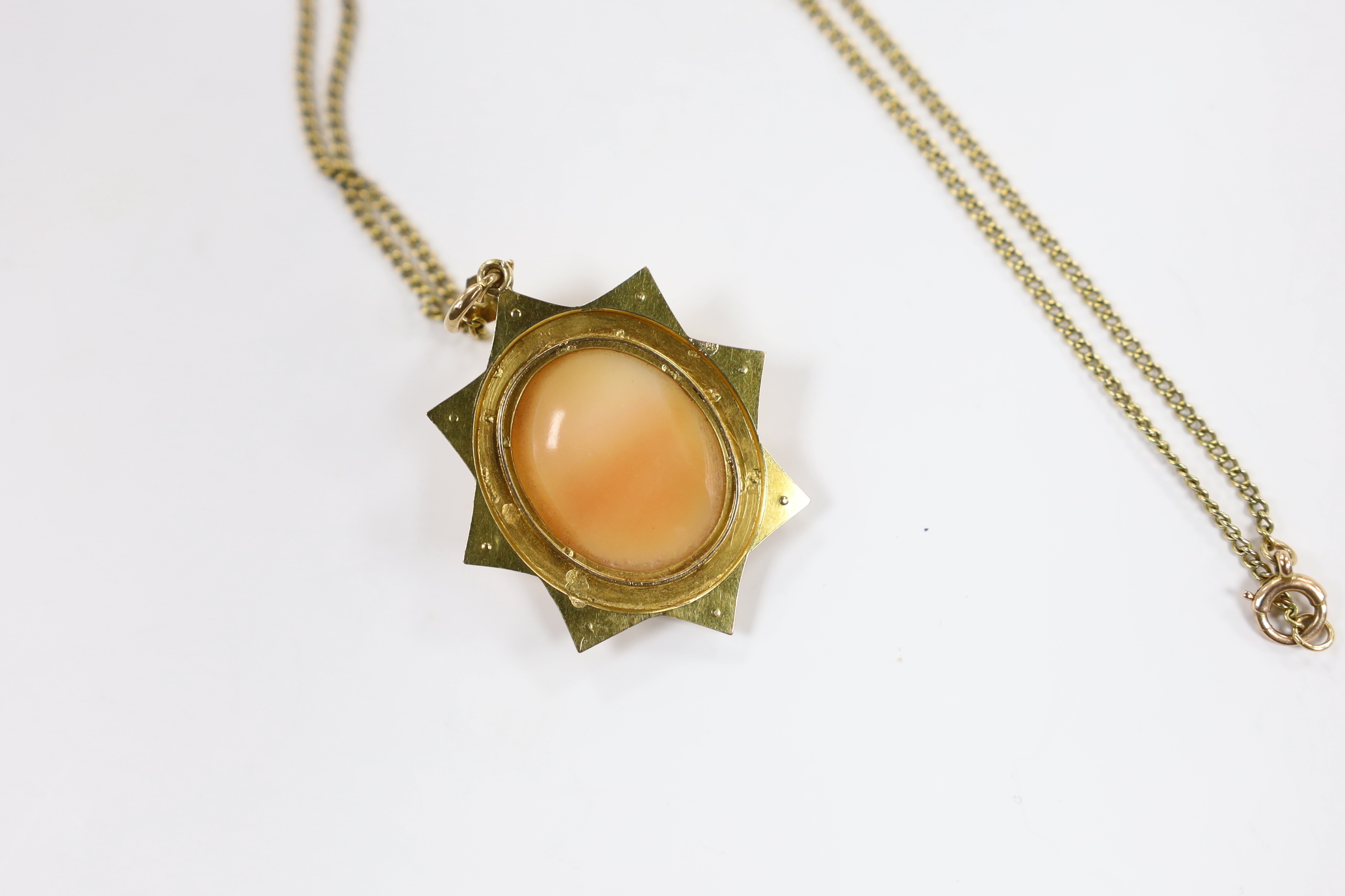 A Victorian yellow metal and seed pearl set cameo shell pendant, 40mm on a 15ct fine link chain, 44cm, gross weight 9.1 grams.